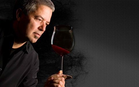 Greg Linn looking at glass of wine